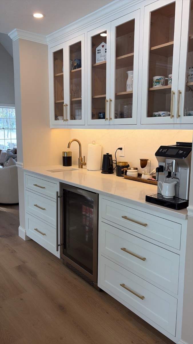 Custom white coffee bar hutch with glass cabinets