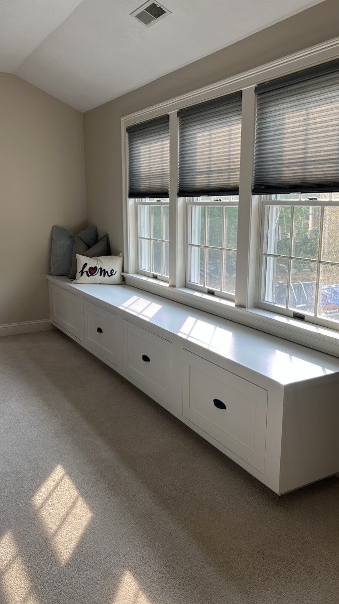 Custom glossy white window seat with ocean view