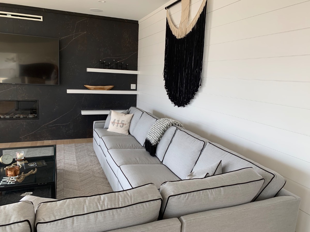 Custom floating shelves on a black marble wall