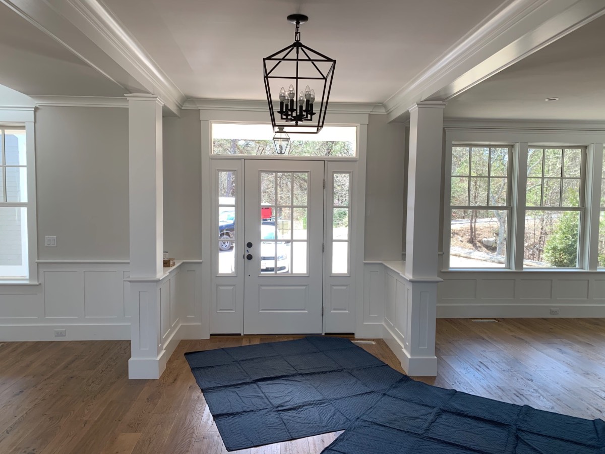 Shiplap fireplace wall with custom wood mantel and coffered ceiling