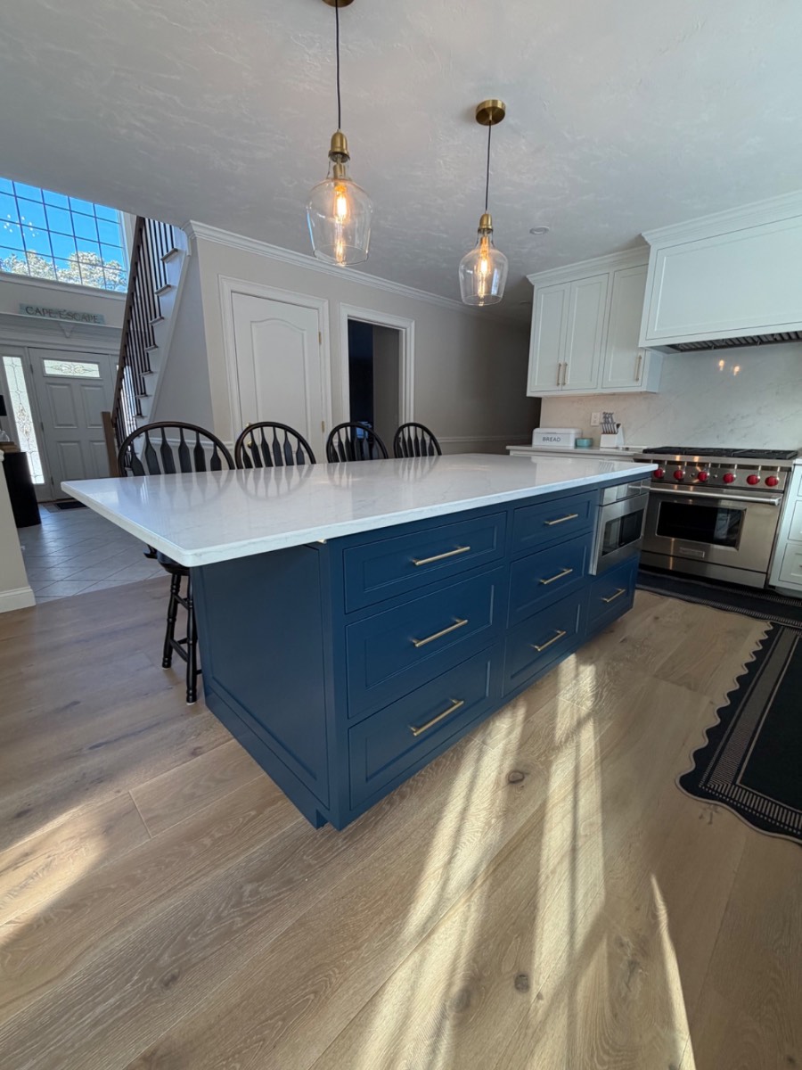 Custom navy blue kitchen island with white quartz top