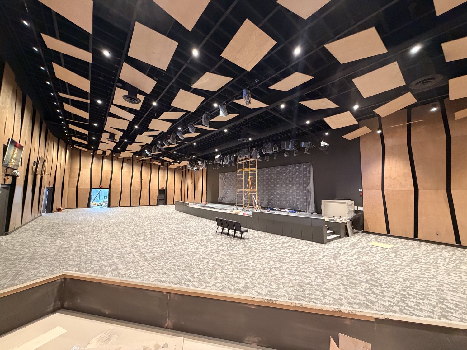 Reach Church auditorium finished β acoustic wood ceiling clouds, wall paneling, and stage